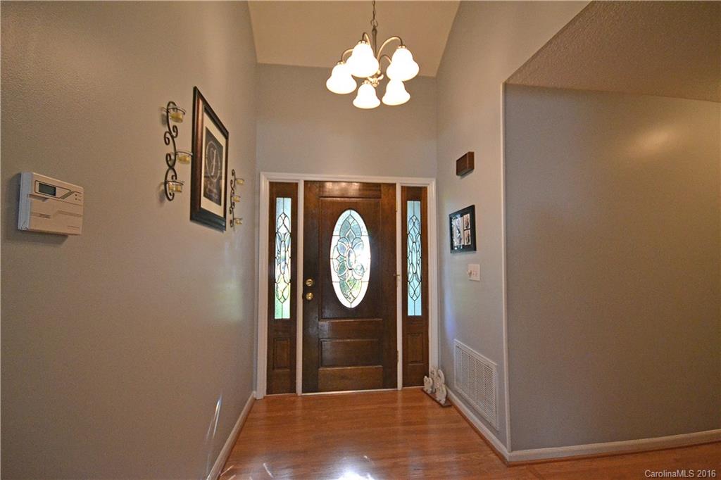 3070 Point Clear Drive Tega Cay, SC 29708 - Photo 2 of 22 a view of a livingroom with a chandelier fan and a bathroom