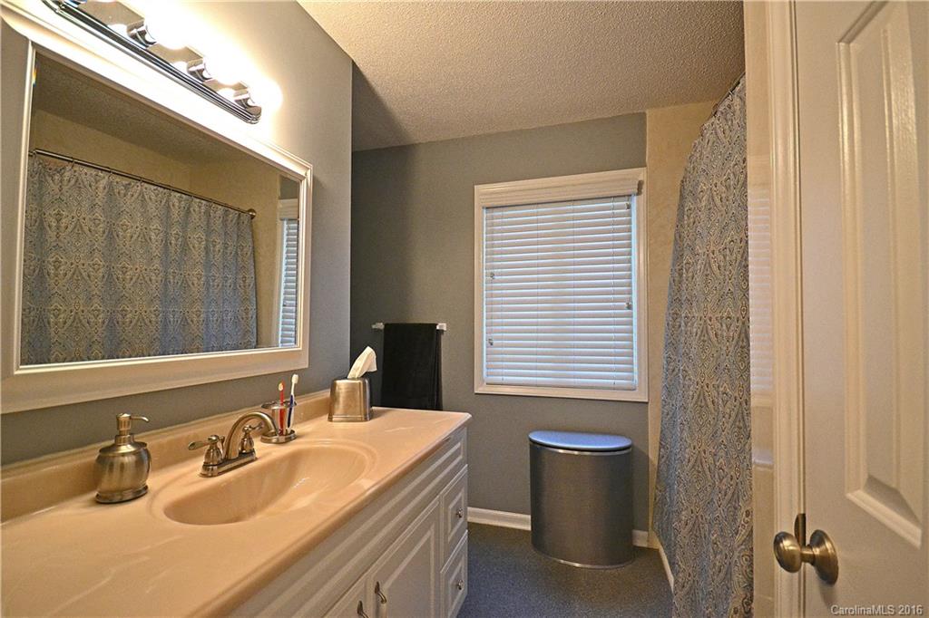 3070 Point Clear Drive Tega Cay, SC 29708 - Photo 12 of 22 a bathroom with a sink a toilet and shower