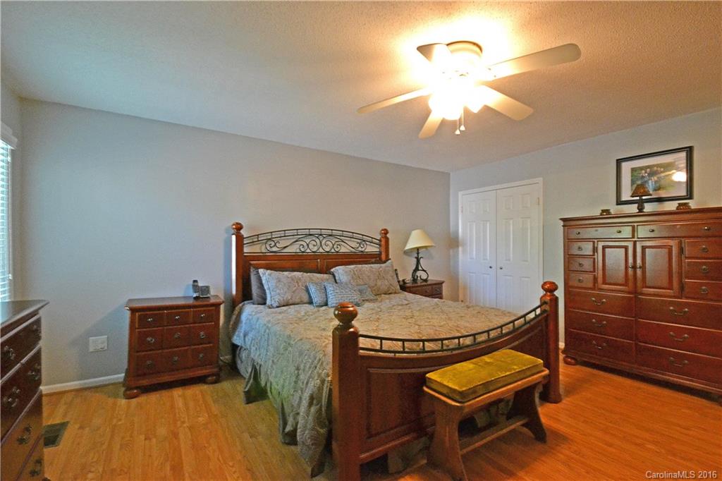 3070 Point Clear Drive Tega Cay, SC 29708 - Photo 13 of 22 a bed room with a bed and a chandelier