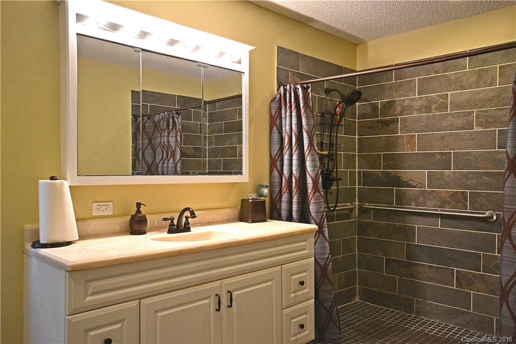 3070 Point Clear Drive Tega Cay, SC 29708 - Photo 14 of 22 a bathroom with a sink shower and a mirror