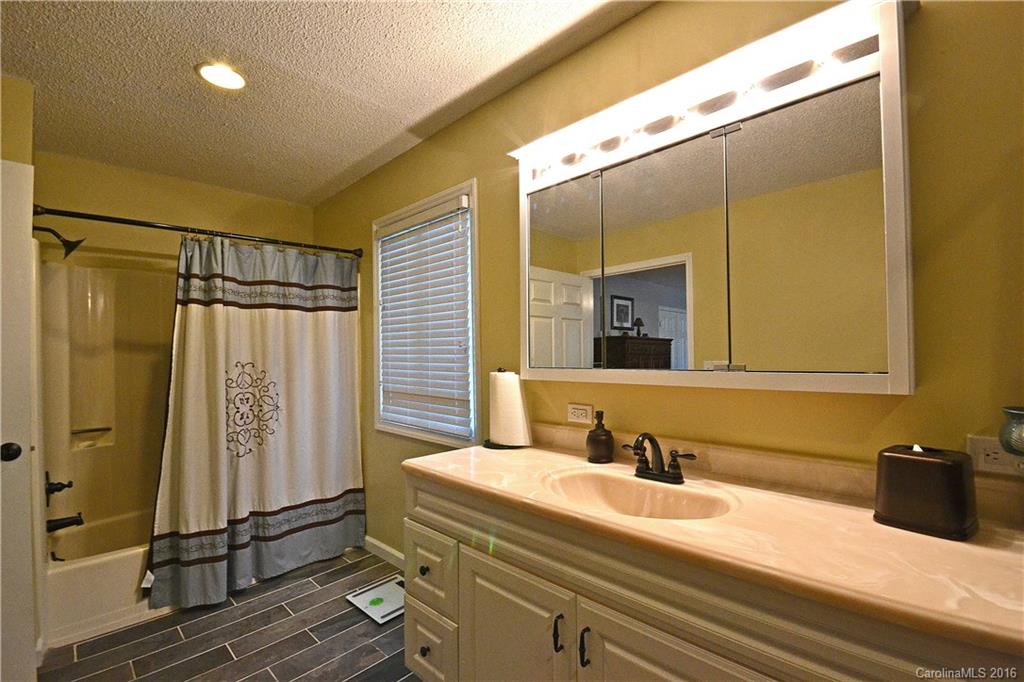 3070 Point Clear Drive Tega Cay, SC 29708 - Photo 15 of 22 a bathroom with a sink and a mirror