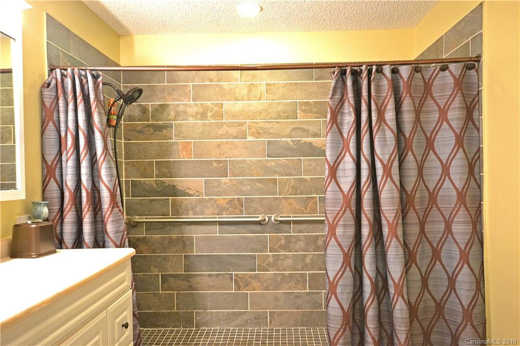 3070 Point Clear Drive Tega Cay, SC 29708 - Photo 16 of 22 a bathroom with a shower curtain and a sink