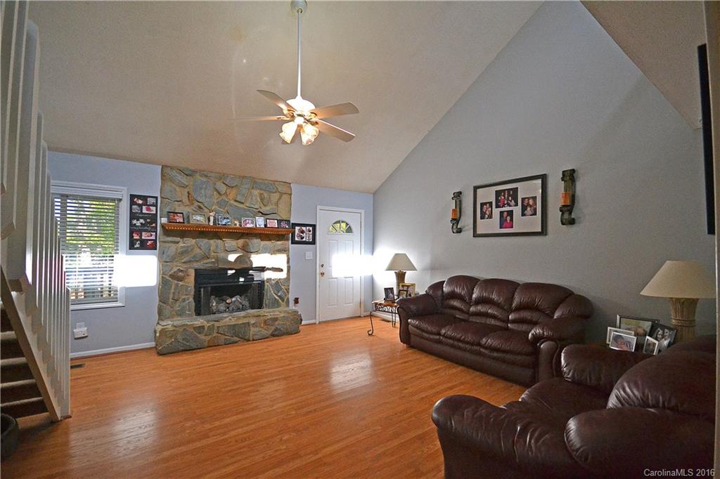3070 Point Clear Drive Tega Cay, SC 29708 - Photo 4 of 22 a living room with furniture a fireplace and wooden floor