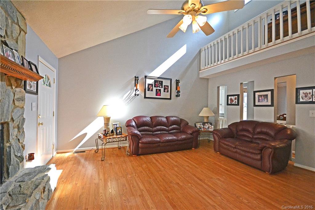 3070 Point Clear Drive Tega Cay, SC 29708 - Photo 6 of 22 a living room with furniture a couch and a flat screen tv