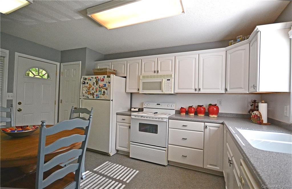 3070 Point Clear Drive Tega Cay, SC 29708 - Photo 8 of 22 a kitchen with a white cabinets and white appliances