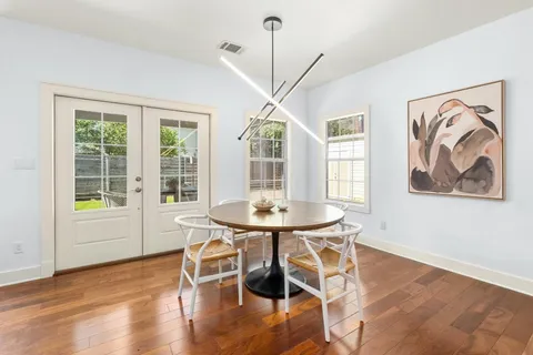 a view of a dining room with furniture window and wooden floor