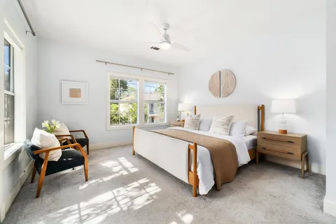 a spacious bedroom with a bed and window