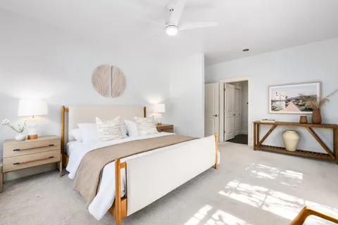 a bedroom with bed and a table