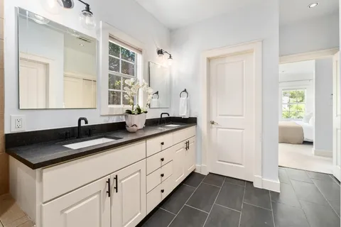 a kitchen with granite countertop white cabinets and sink