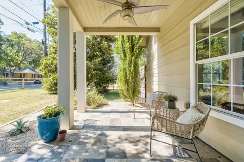a view of a patio with couches chairs and potted plants