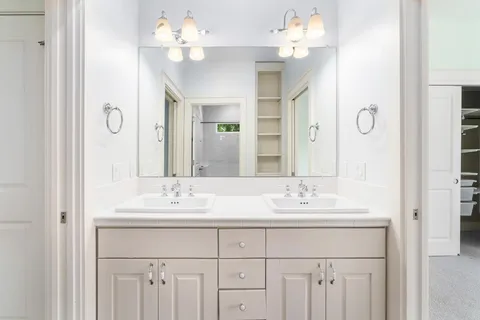 a bathroom with a sink vanity and a mirror