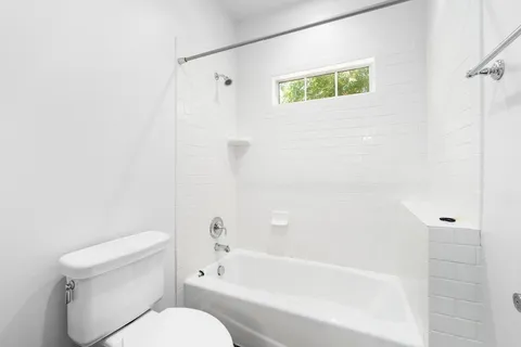 a bathroom with a toilet and a bathtub