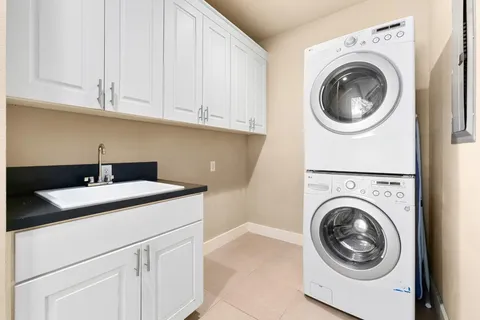 a utility room with sink dryer and washer