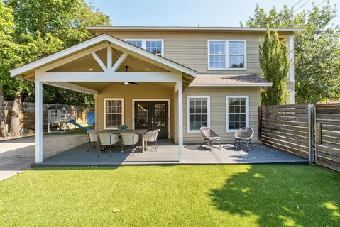 a front view of house with outdoor seating and yard