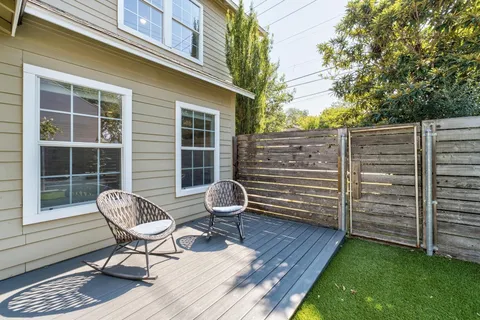 a backyard of a house with childrens swings and slides