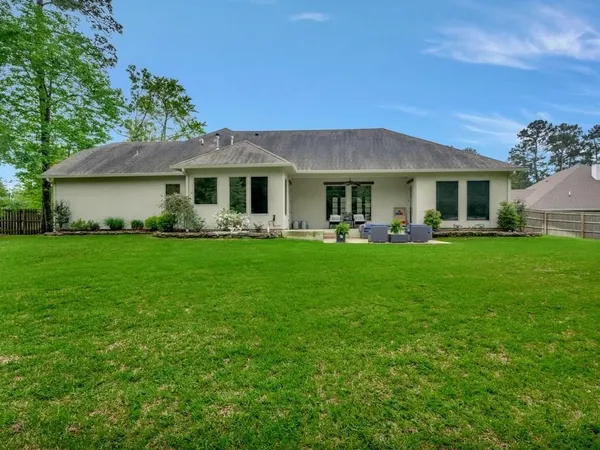 a front view of house with yard and green space