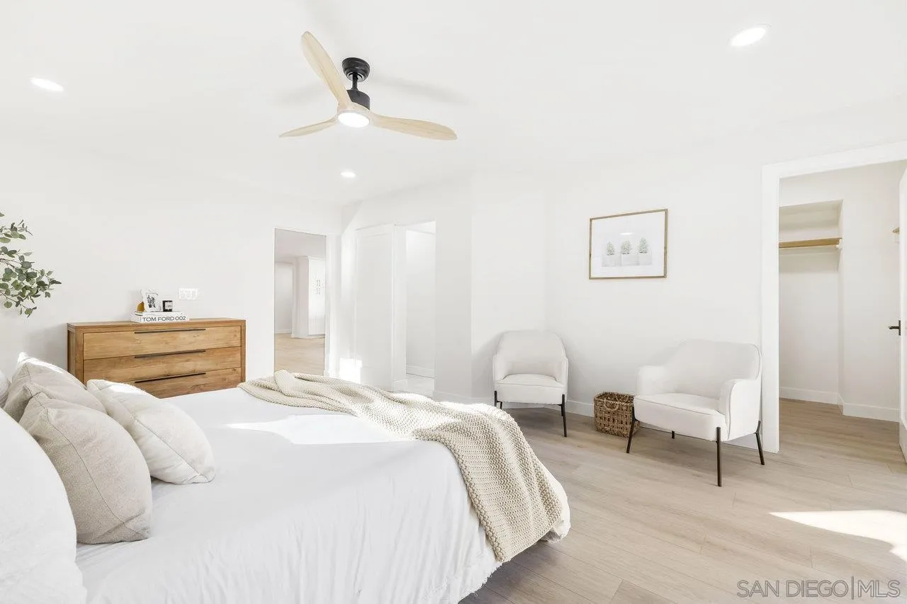 13783 Recuerdo Drive Del Mar, CA 92014 - Photo 29 of 56 a spacious bedroom with a bed and a chair