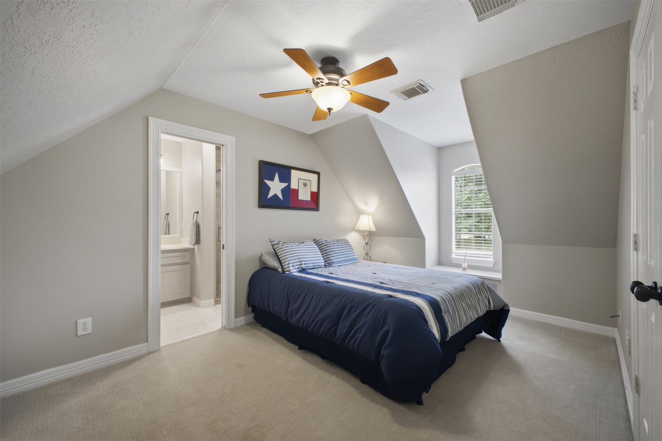 12710 Aries Loop Willis, TX 77318 - Photo 29 of 40 This room features sloped ceilings, carpet flooring, a window with blinds, and a ceiling fan