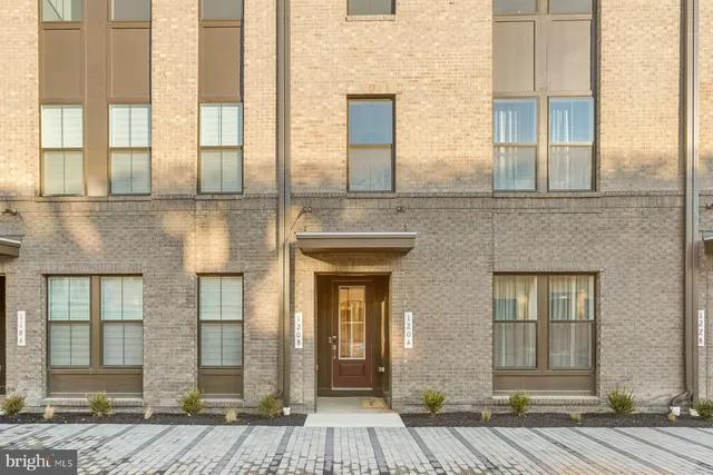 a view of a brick house with large windows