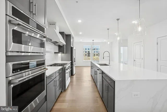 a kitchen with stainless steel appliances granite countertop lots of counter space and a sink