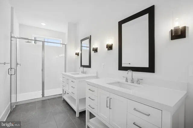 a bathroom with a double vanity sink mirror and