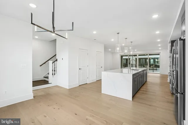 a large room with kitchen view and living room view