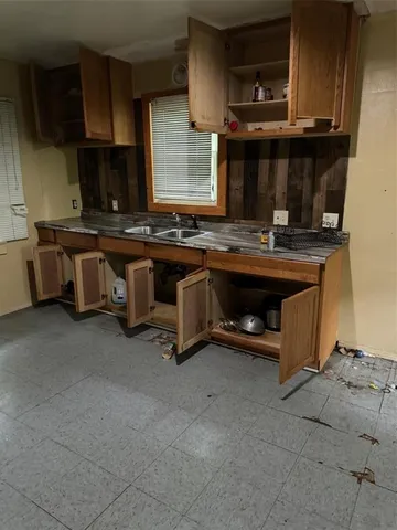a view of a kitchen with a sink and cabinets