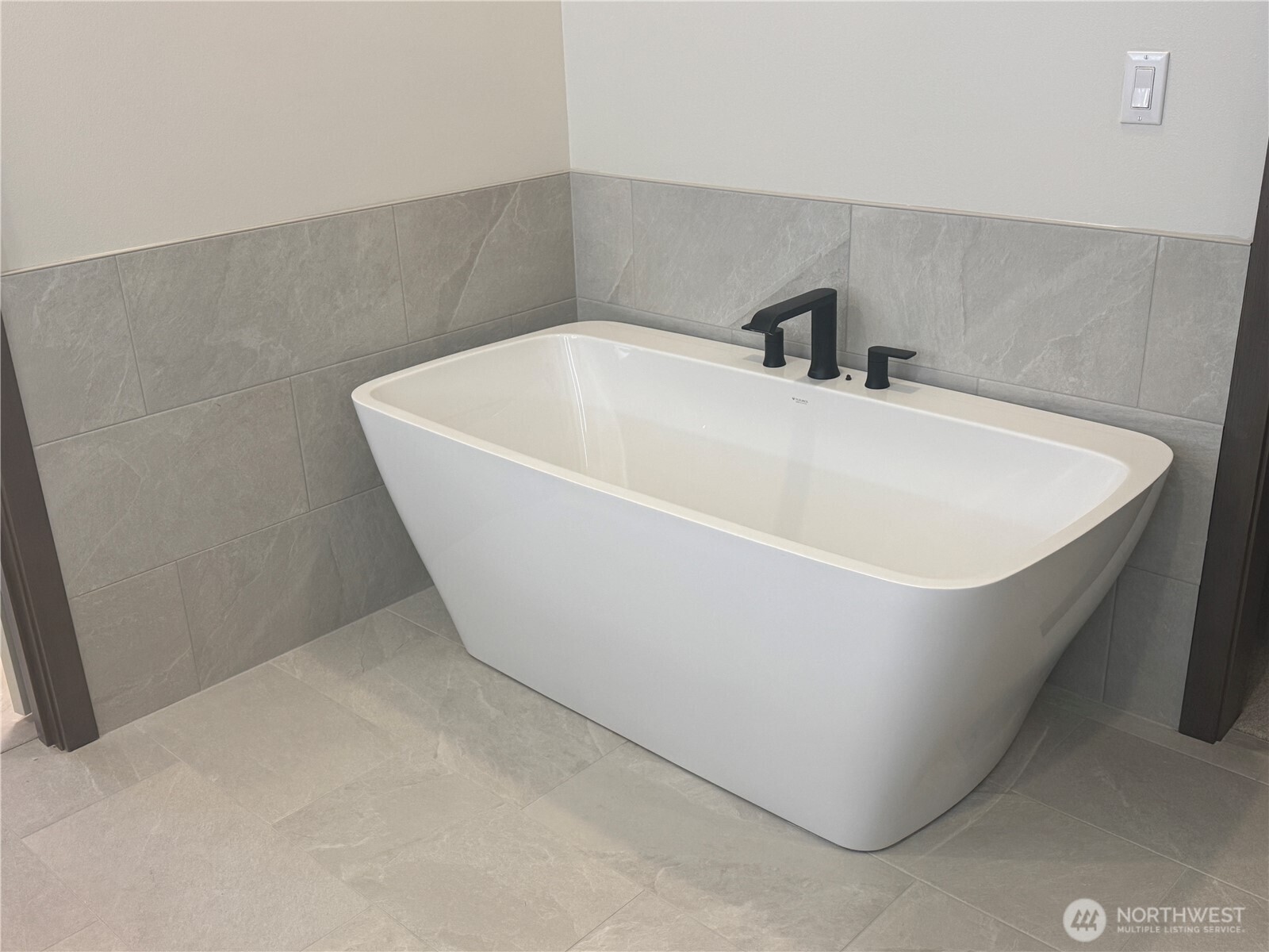 9207 Northeast 175th Street, Unit B Bothell, WA 98011 - Photo 21 of 33 a white bath tub sitting in a bathroom
