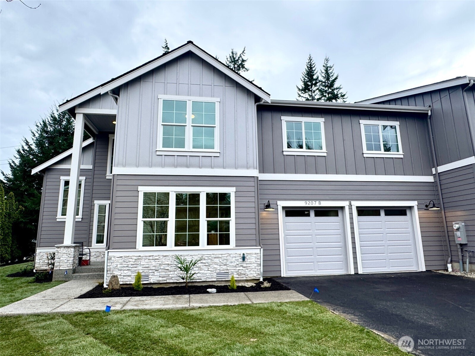 9207 Northeast 175th Street, Unit B Bothell, WA 98011 - Photo 25 of 33 a front view of a house with a yard and garage