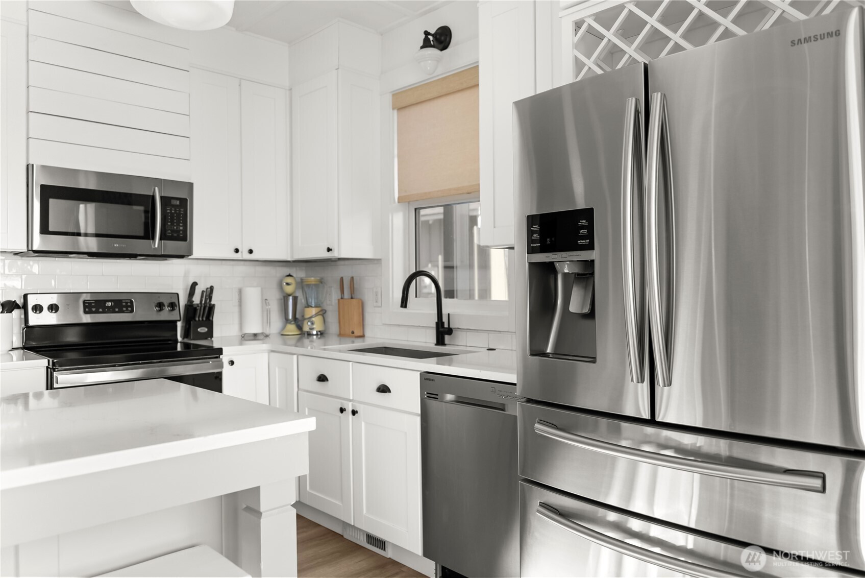 9207 Northeast 175th Street, Unit B Bothell, WA 98011 - Photo 29 of 33 a kitchen with stainless steel appliances a refrigerator sink and microwave