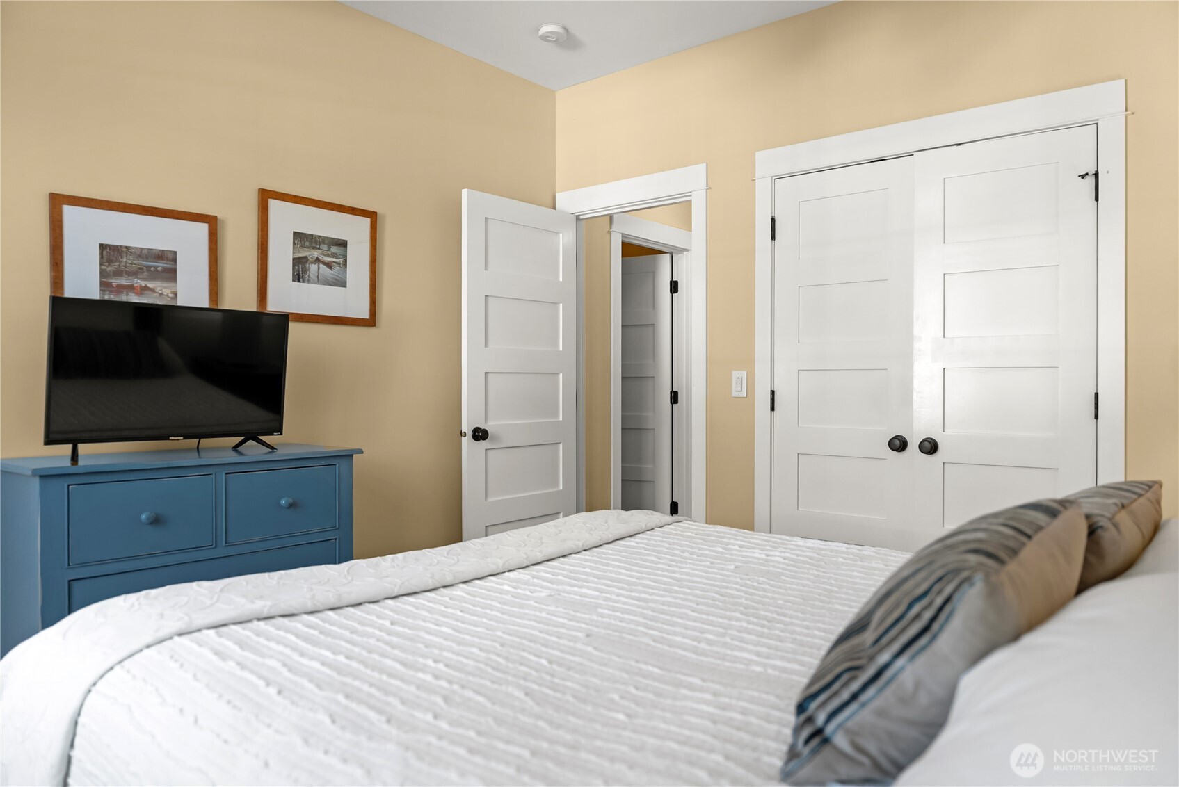 9207 Northeast 175th Street, Unit B Bothell, WA 98011 - Photo 31 of 33 a bedroom with a bed and a flat screen tv