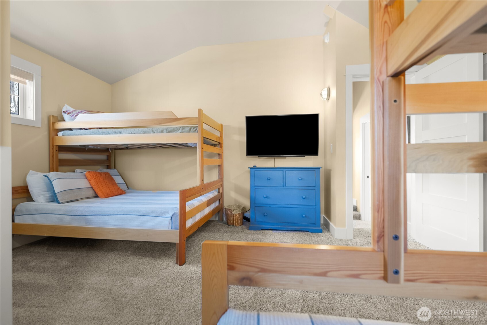 9207 Northeast 175th Street, Unit B Bothell, WA 98011 - Photo 32 of 33 a bedroom with a bed and flat screen tv