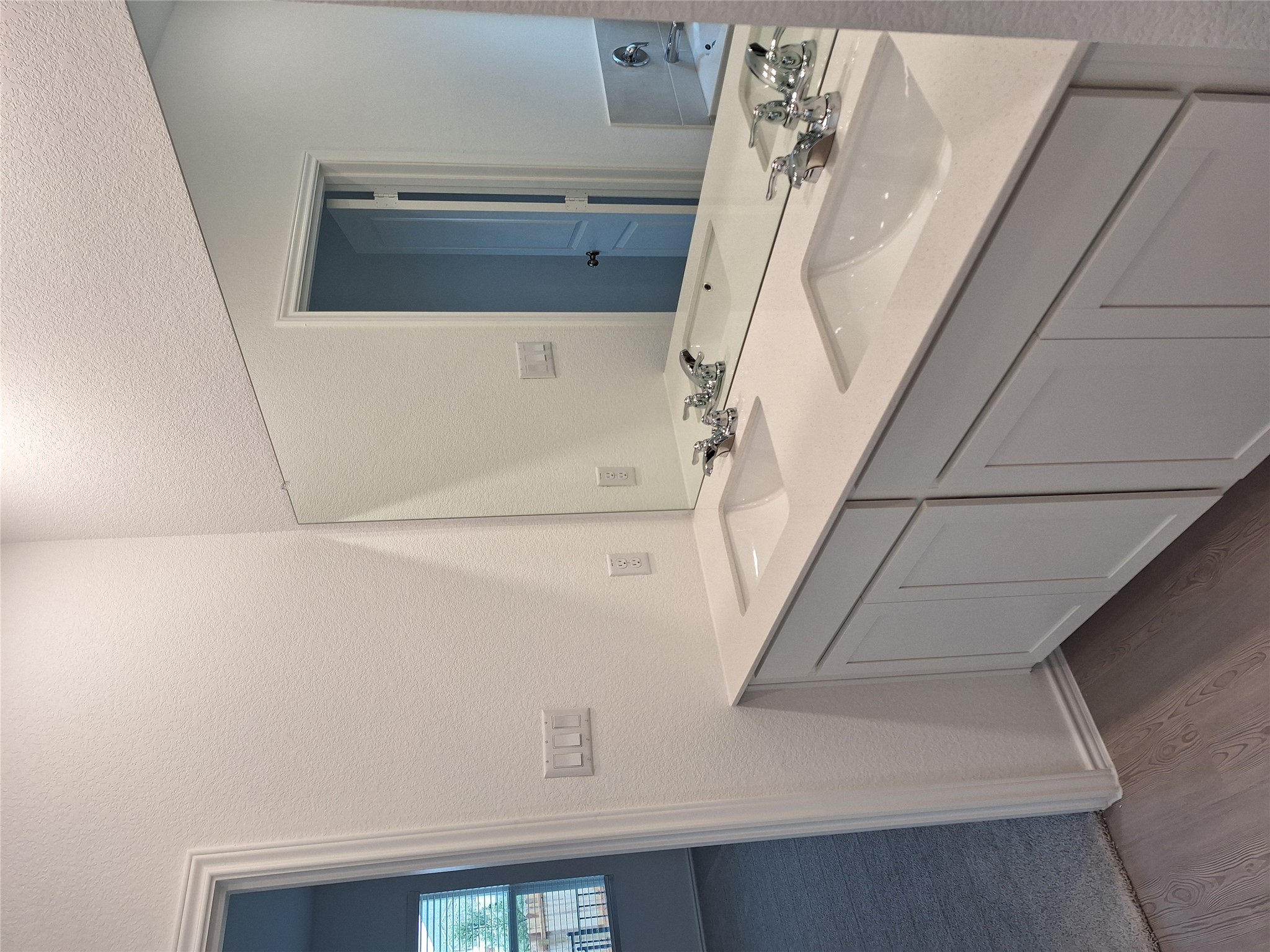 18001 Prairie Falcon Way Pflugerville, TX 78660 - Photo 27 of 38 Dual vanity featuring white shaker-style cabinetry, integrated rectangular sinks, and a large wall-mounted mirror