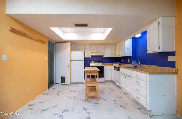 a kitchen with a sink and a refrigerator
