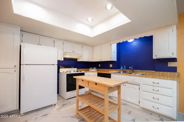 a kitchen with stainless steel appliances a refrigerator sink and cabinets
