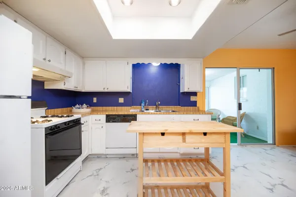 a kitchen with a stove a sink and a refrigerator