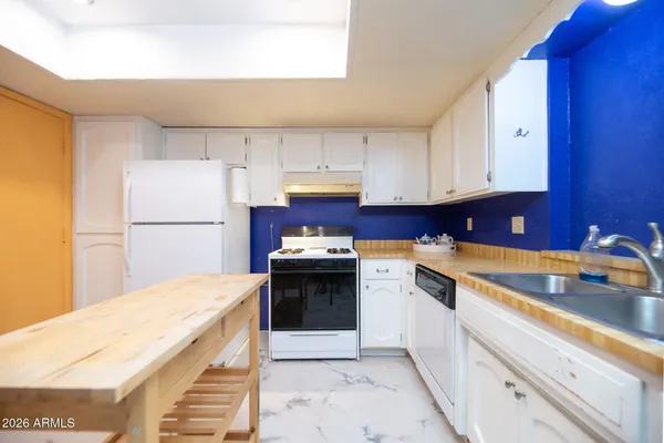 a kitchen with a sink cabinets and appliances