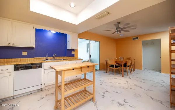 a kitchen with a sink and chairs