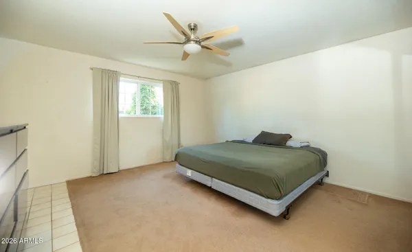 a bedroom with a bed and window