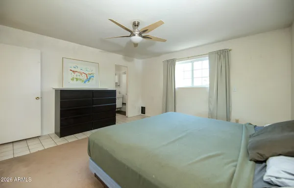 a bedroom with a bed and a dresser