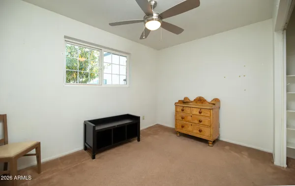 a room with a dresser and a window