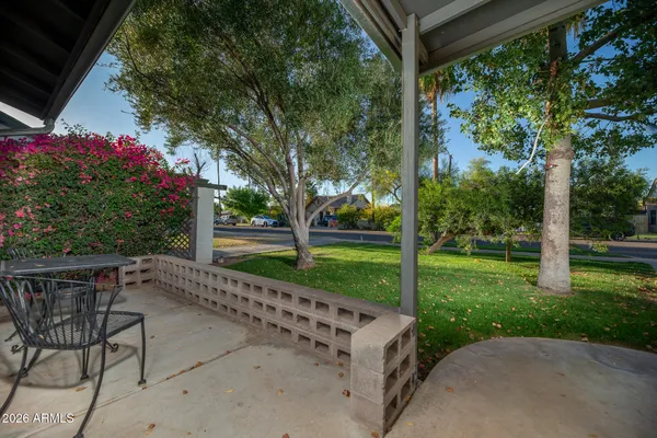 a view of a chair and table in the garden