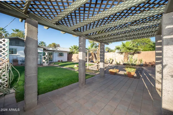 a view of a porch with furniture and garden