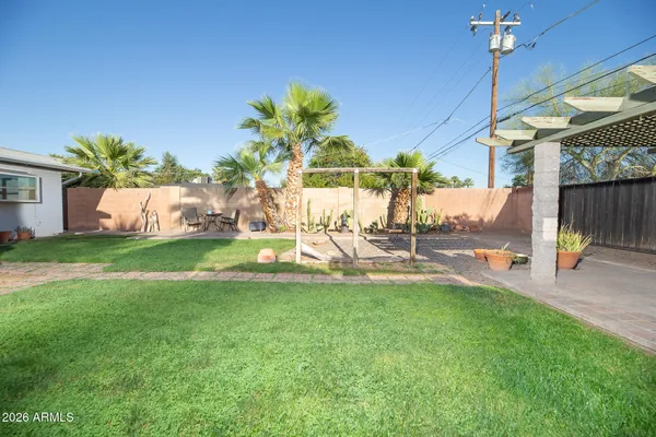 a view of a house with a backyard porch and sitting area
