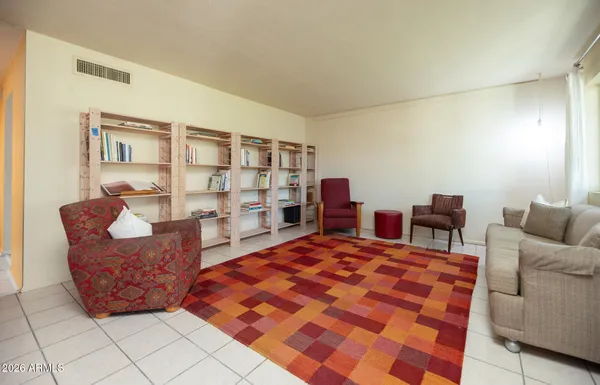 a living room with furniture a rug and a table