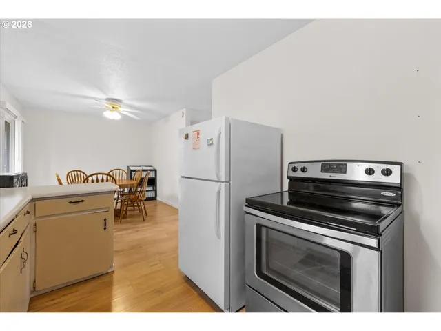 a kitchen with a stove and a refrigerator