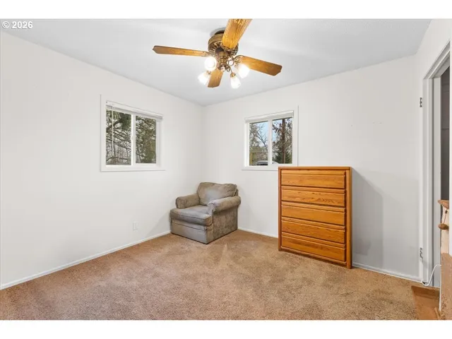 a living room with furniture and a ceiling fan