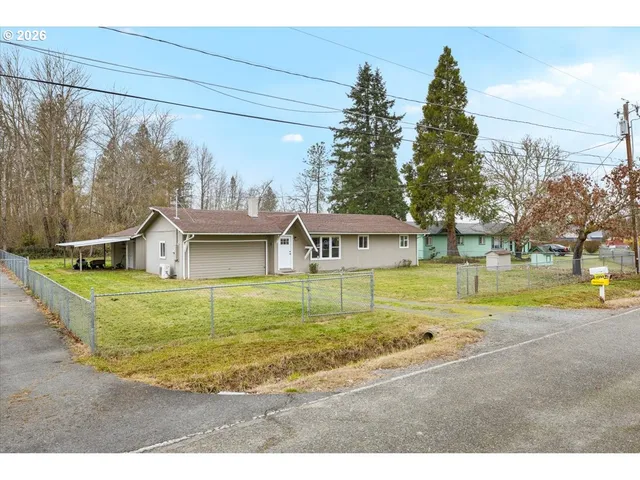 a view of a house with a yard and sitting area