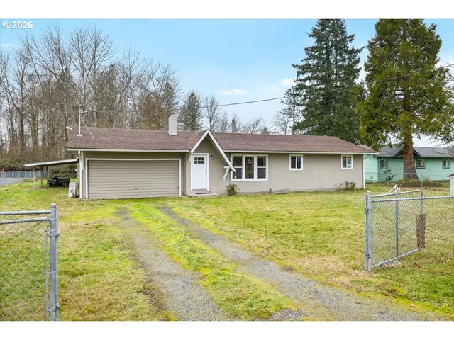 a backyard of a house with table and chairs