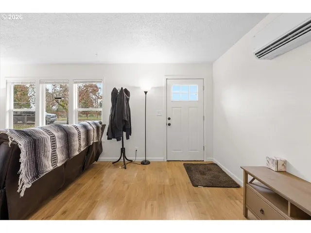a bedroom with a bed and a flat tv screen on the dresser